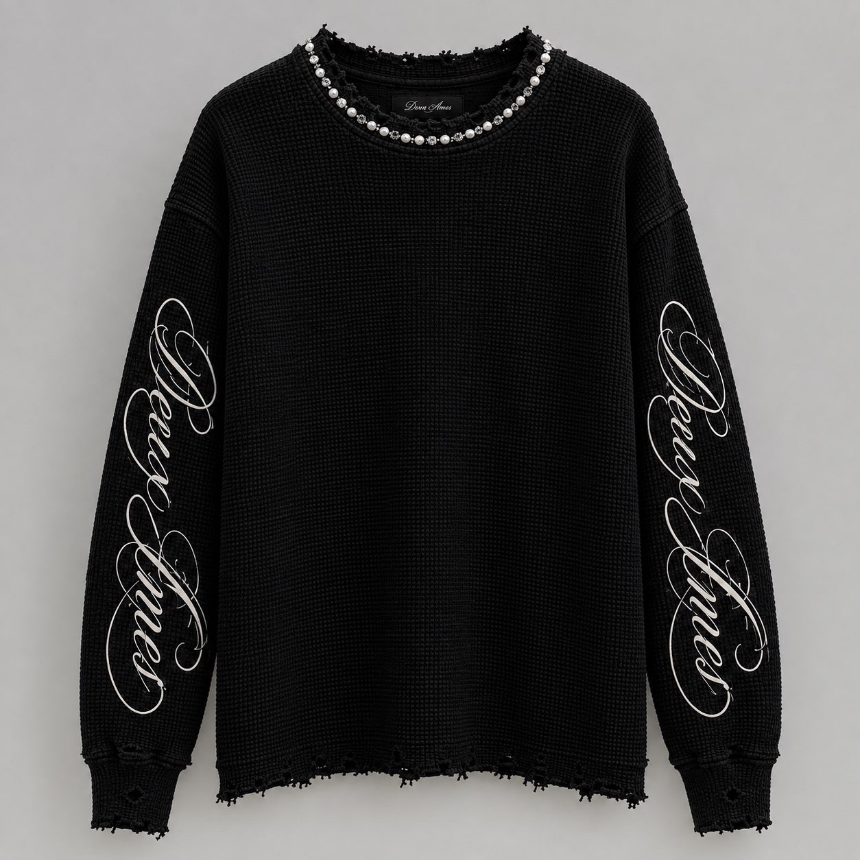 Black distressed knit Deux Âmes sweater with pearl neckline and script sleeves